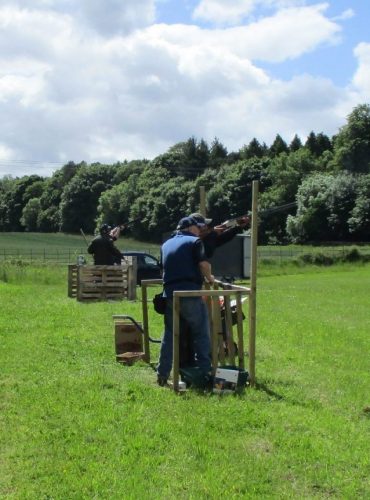 A man instructs someone at a clay pigeon shooting stag party near Edinburgh. A man instructs someone at a clay pigeon shooting stag party near Edinburgh.