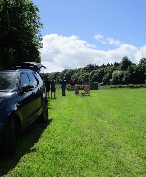 A vehicle parked in a field away from the group A vehicle parked in a field away from the group